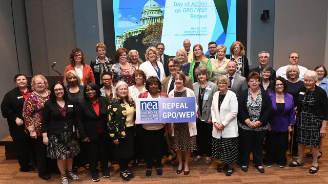 NEA members pose as a group with a sign that says repeal GPO/WEP